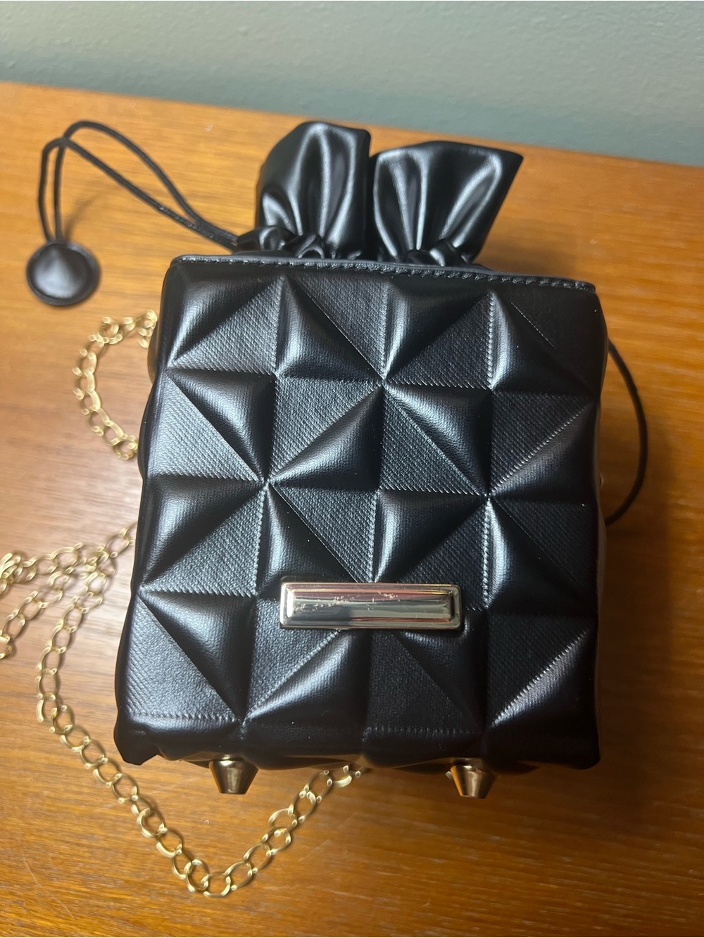 Black Quilted Mini Drawstring Crossbody Bag with Gold Chain